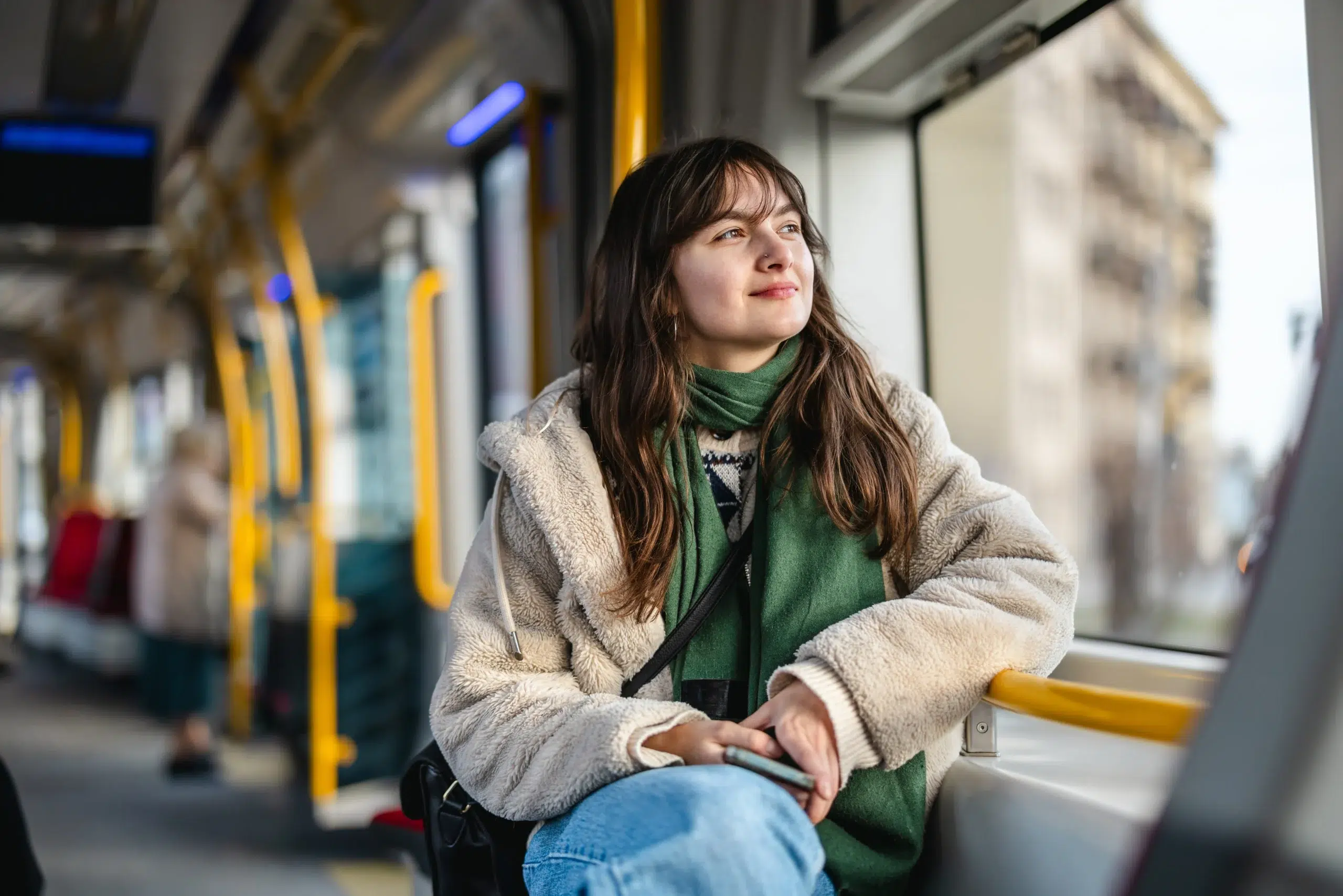 Woman riding public transit while thinking about debt consolidation options and managing multiple debts